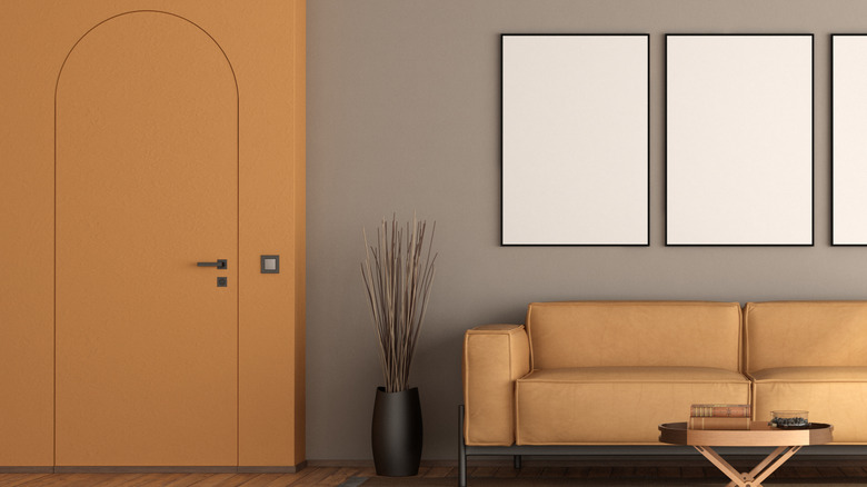 Living room with furniture and a frameless door