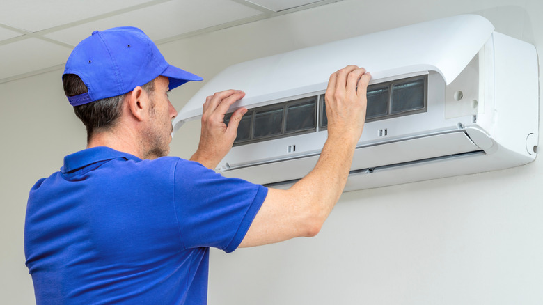 Man installs an air conditioner