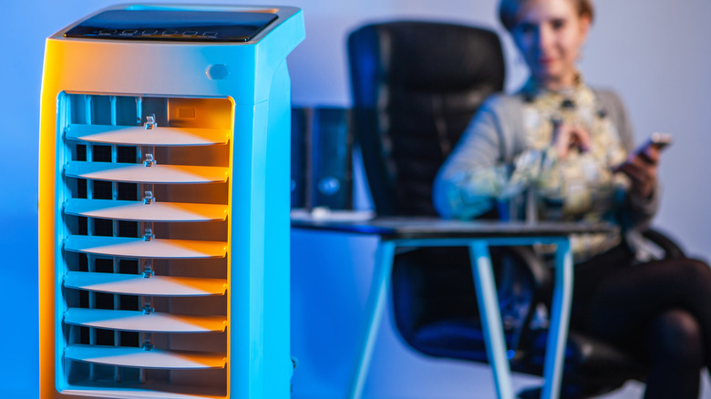 woman sitting behind air conditioner