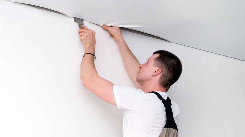man installing ceiling