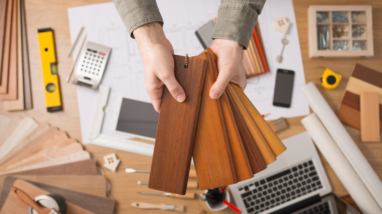 Hands holding wood flooring samples