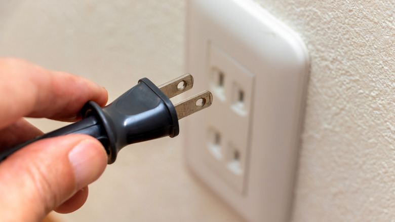 plugging in electrical socket