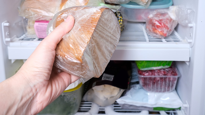 Hand reaching into freezer