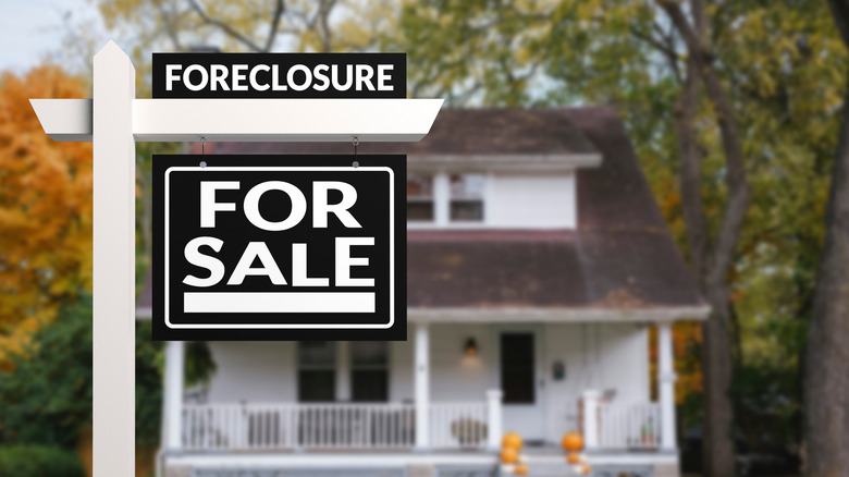 foreclosure sign in front of home