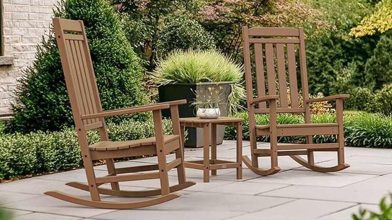 Set of teak Cracker Barrel rocking chairs with a side table.