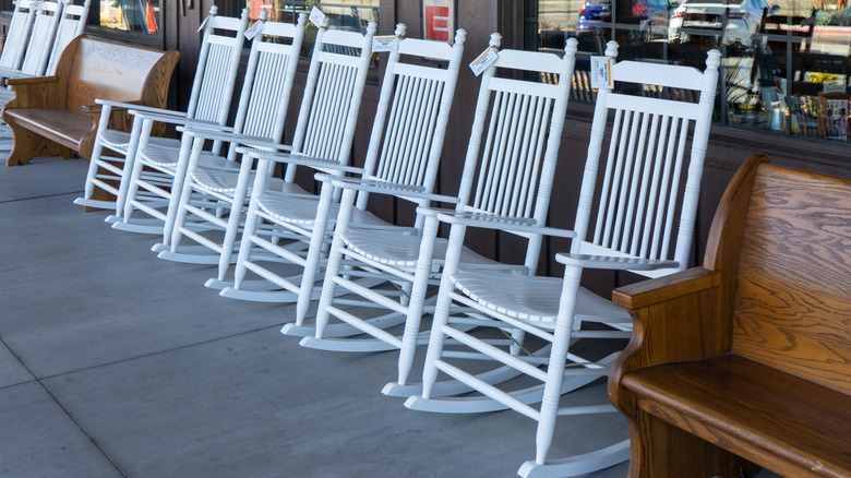 White Cracker Barrel rocking chairs lined up in front of the restaurant.