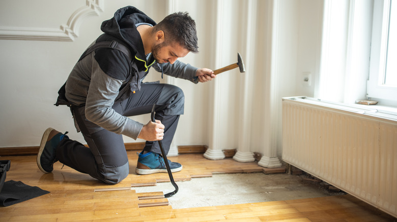 wood floor planks being removed