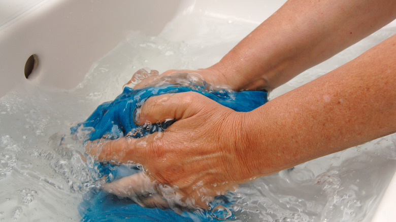 Close-up of a cloth being rinsed under water