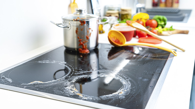 A close up look at white filmy stains on a glass stovetop.