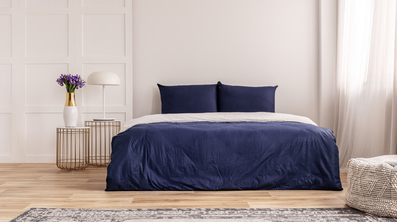 blue bed in a white bedroom