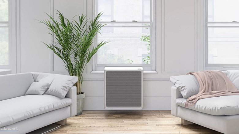 a window installed heat pump offers a sleek appearance in an all white living room