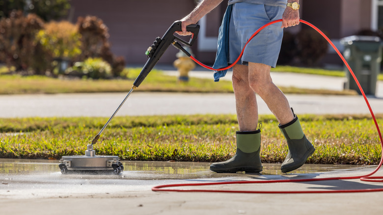 Person cleaning a driveway