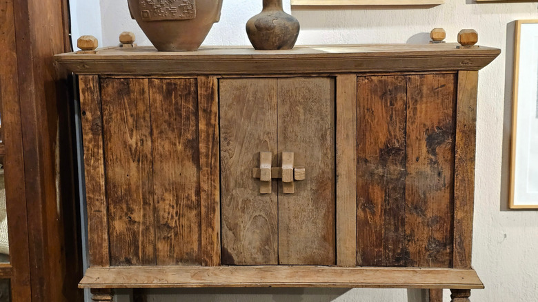 a rustic antique wooden cabinet