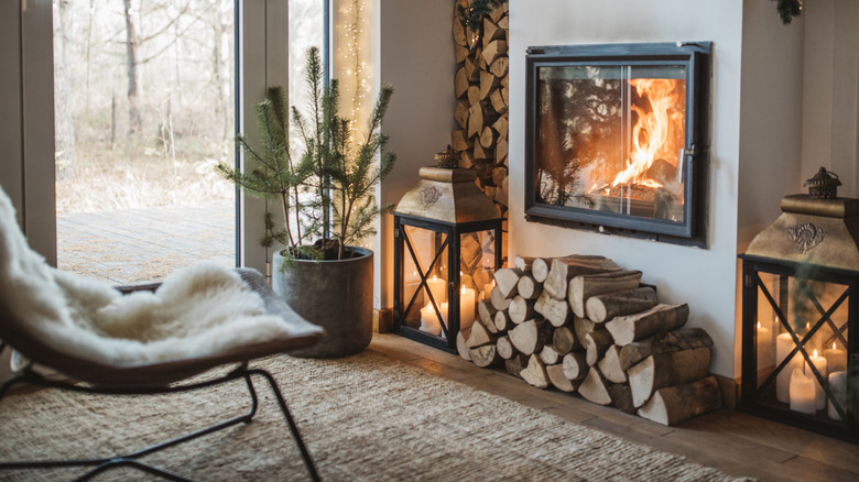 Winter scene with lit fireplace and cozy elements