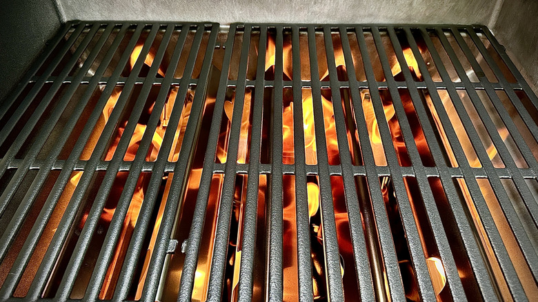 Gas grill burning yellow flames.