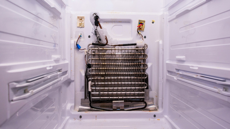 A refrigerator's evaporator fan that has ice frozen onto it