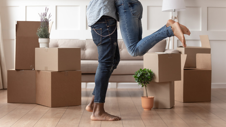 Happy couple with moving boxes