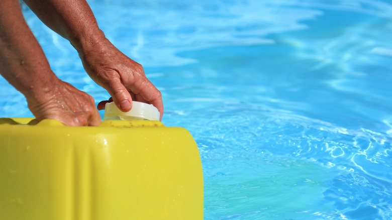 adding chemicals to pool