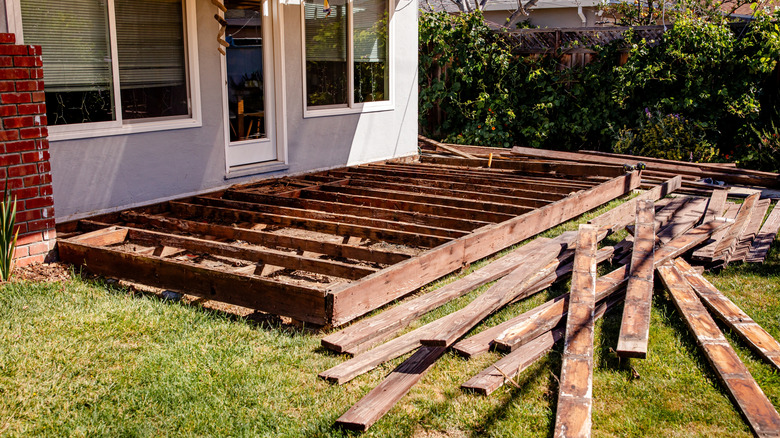 Old wood deck with the boards removed to prepare for replacement