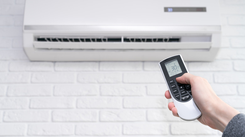 Person using an air conditioner remote