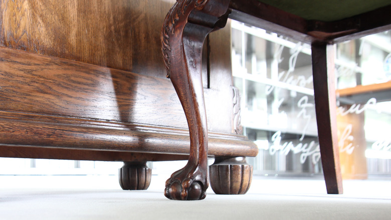 close up of ball and claw foot furniture leg