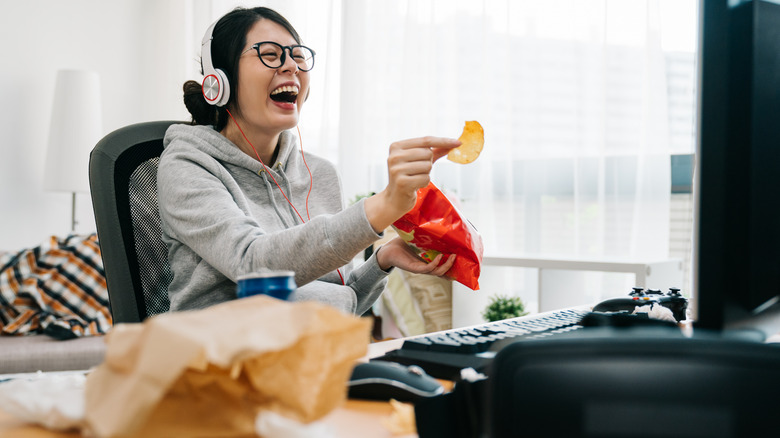 Woman laughing at computer
