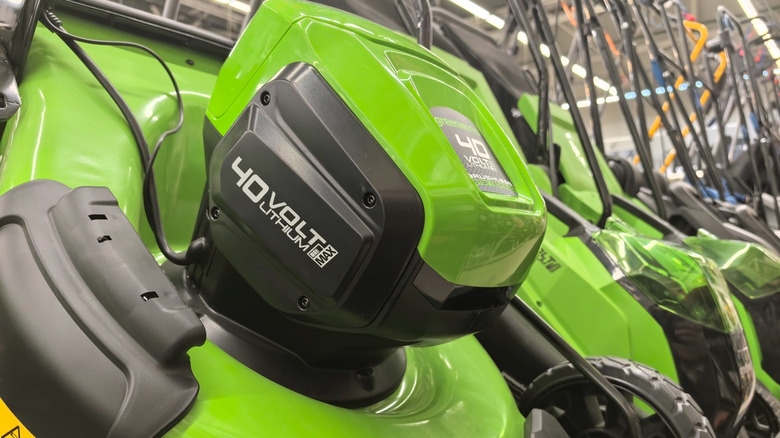 Row of green 40-volt lithium-ion lawn mowers