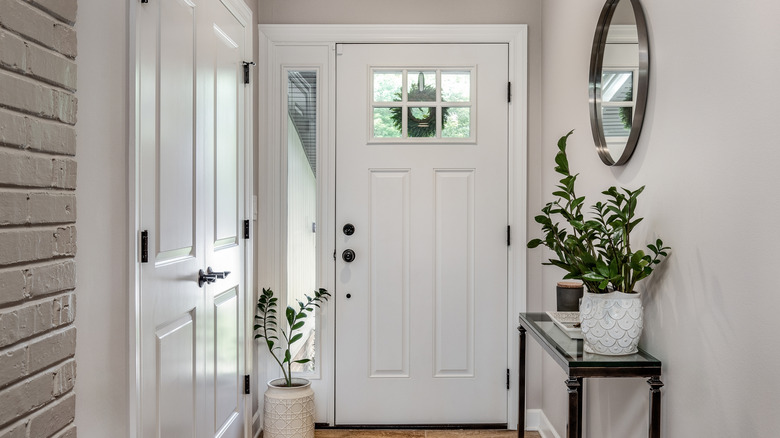 A slim console table with minimal decorations in an entryway