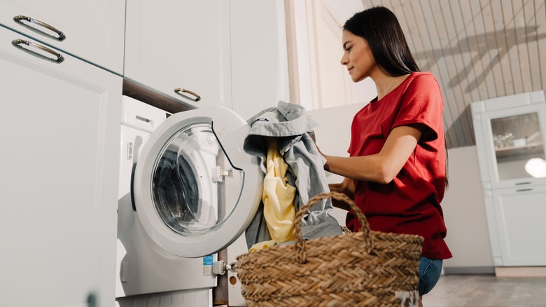 Woman in red shirt doing laundry
