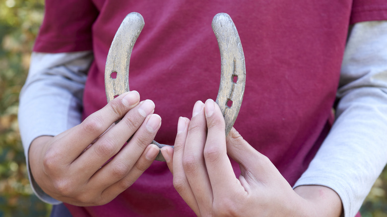 child holding a horseshoe