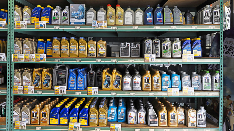 Multi-grade motor oil products displayed at repair shop garage service station.