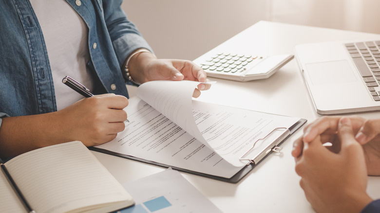 Person signing apartment lease