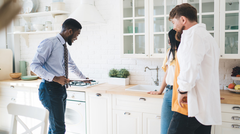 Property manager examining stove