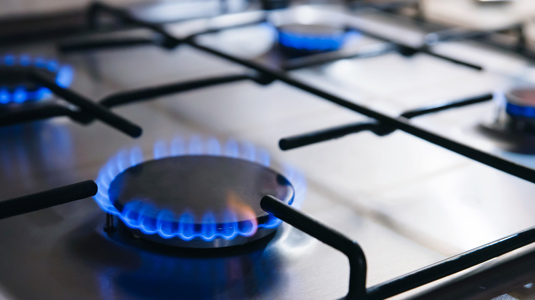 A gas stove with lit burners