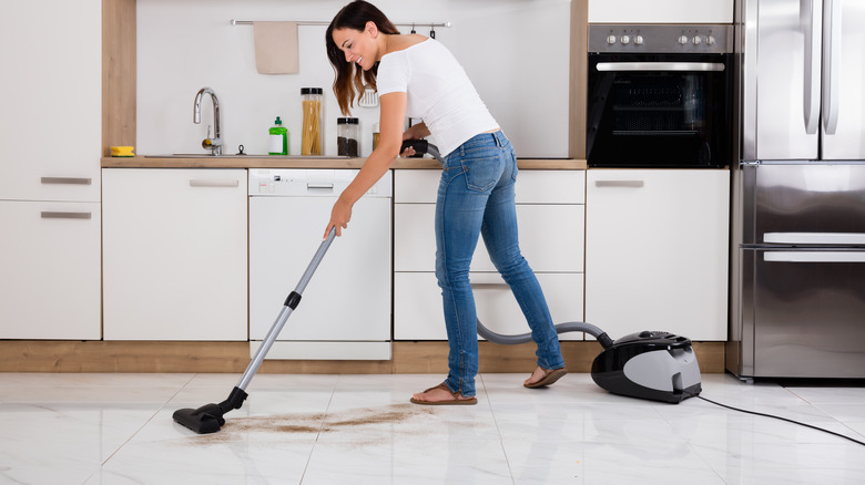 Woman vacuuming coffee grounds