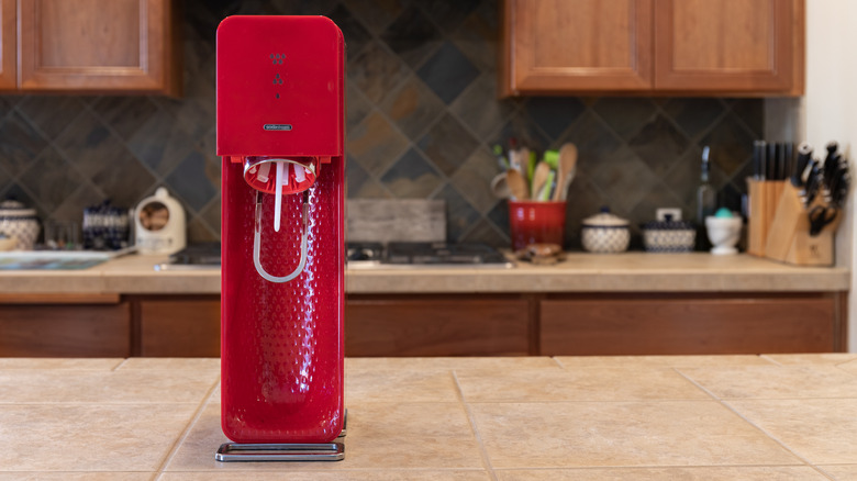 red sodastream machine kitchen counter