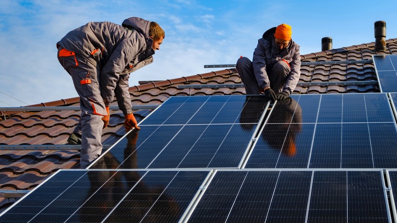 Men installing solar panels