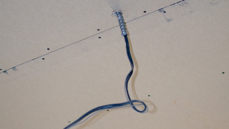 Wiring sticking out a ceiling through hole