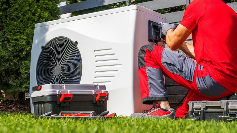 technician inspecting AC unit