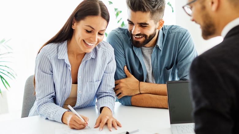 Couple signing contract with agent