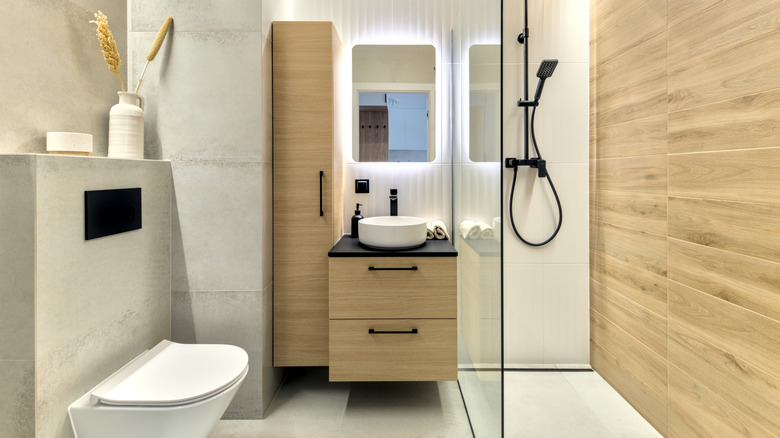Modern bathroom with walk in shower and light wood