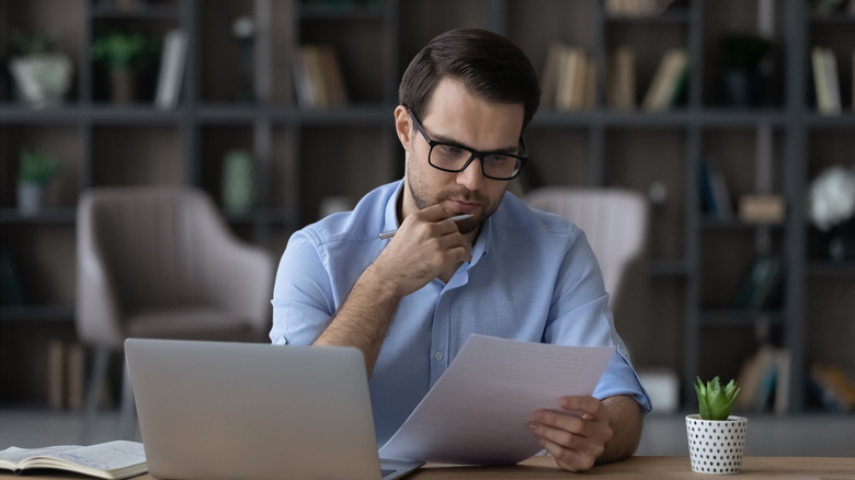 man considering loan documents