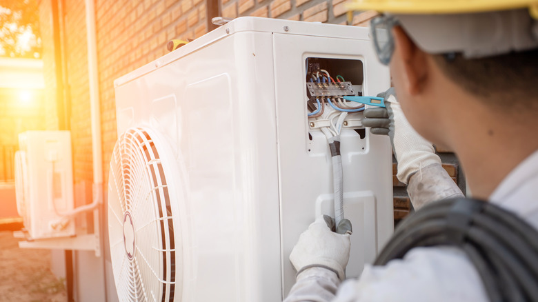 man installing air conditioning unit