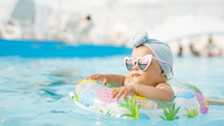 child swimming in pool