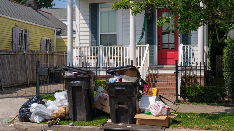A house with excess trash out in front of it