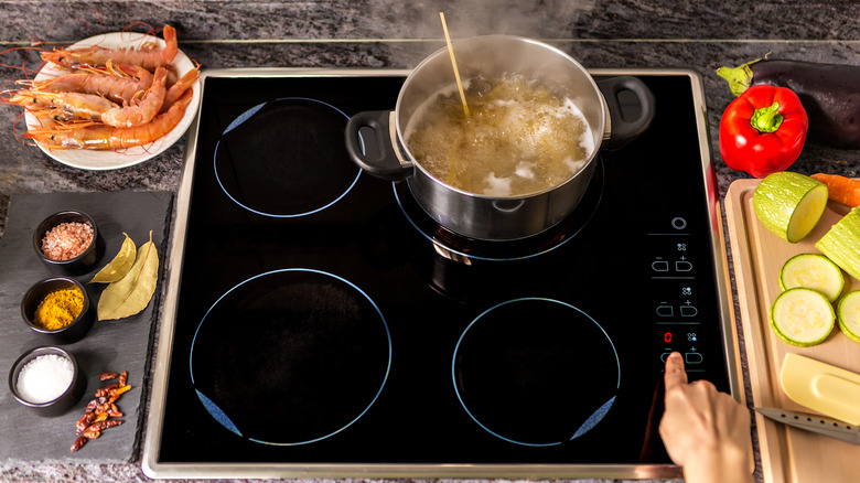 Electronic stove with a pot of boiling pasta.