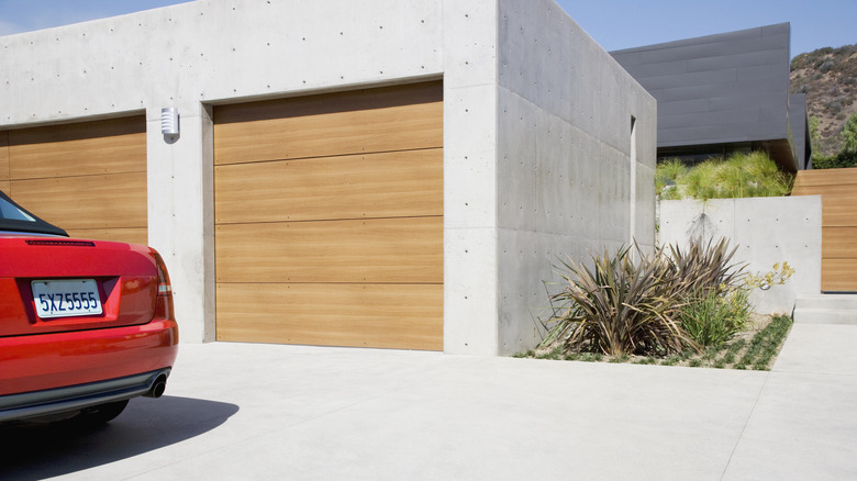 Wooden tilt-out garage doors offer a styling addition to a home