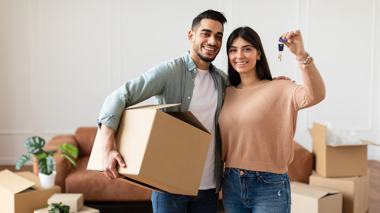 young couple unpacking at new house