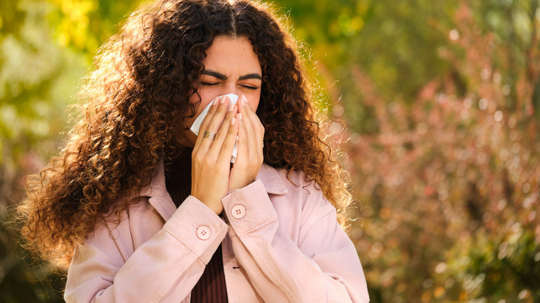 Someone blowing their nose while they're outside