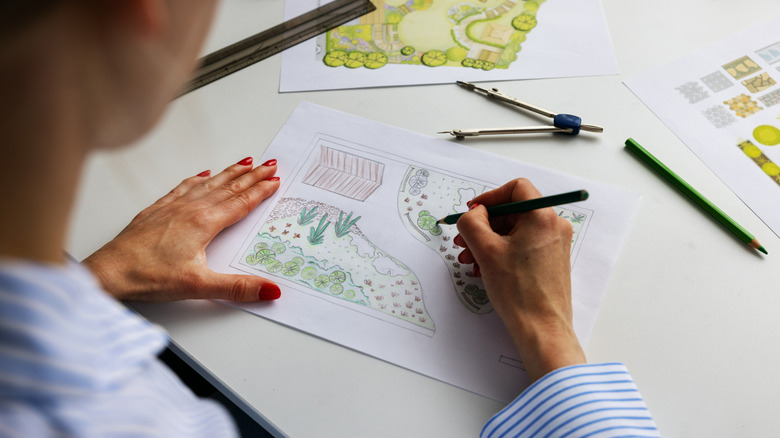 Landscaper drawing out plans for yard.